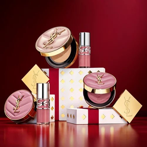 Productos de maquillaje YSL con cajas de regalo festivas.