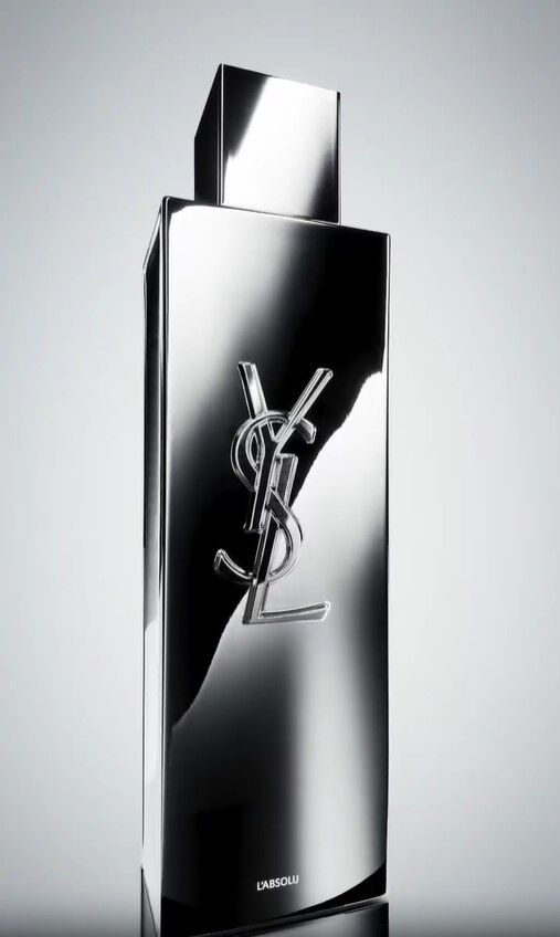 Sleek silver perfume bottle with YSL logo and 'L'ABSOLU' inscription.