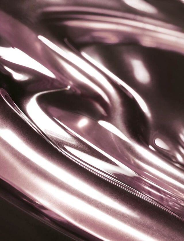 Abstract image featuring smooth, flowing surfaces with a glossy, metallic finish in shades of pink and silver.