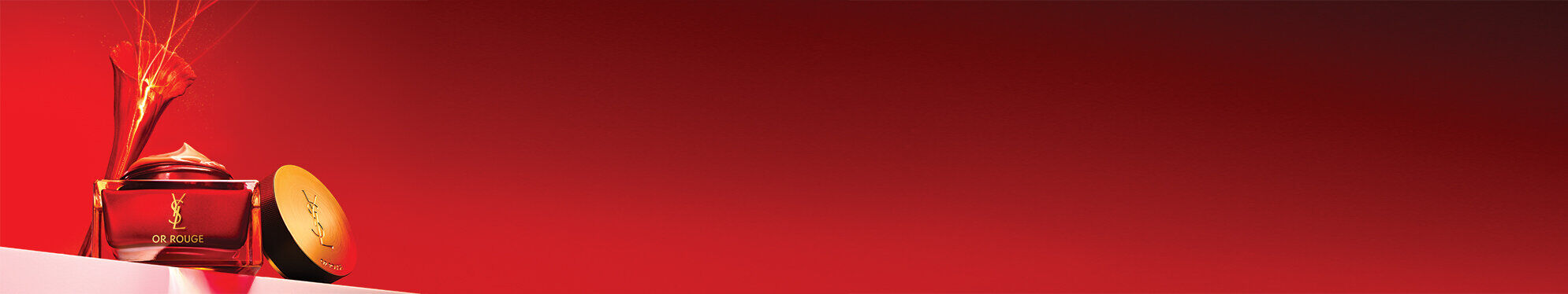 A luxurious jar of cream and an elegant compact on a gradient red background, conveying a sense of richness and elegance.