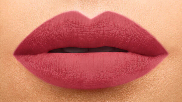 Close-up of smooth, matte lips in a soft rose shade.