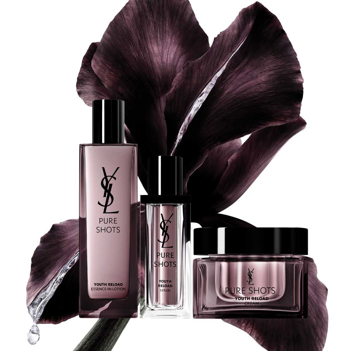 Productos de cuidado YSL Pure Shots frente a un fondo floral oscuro.