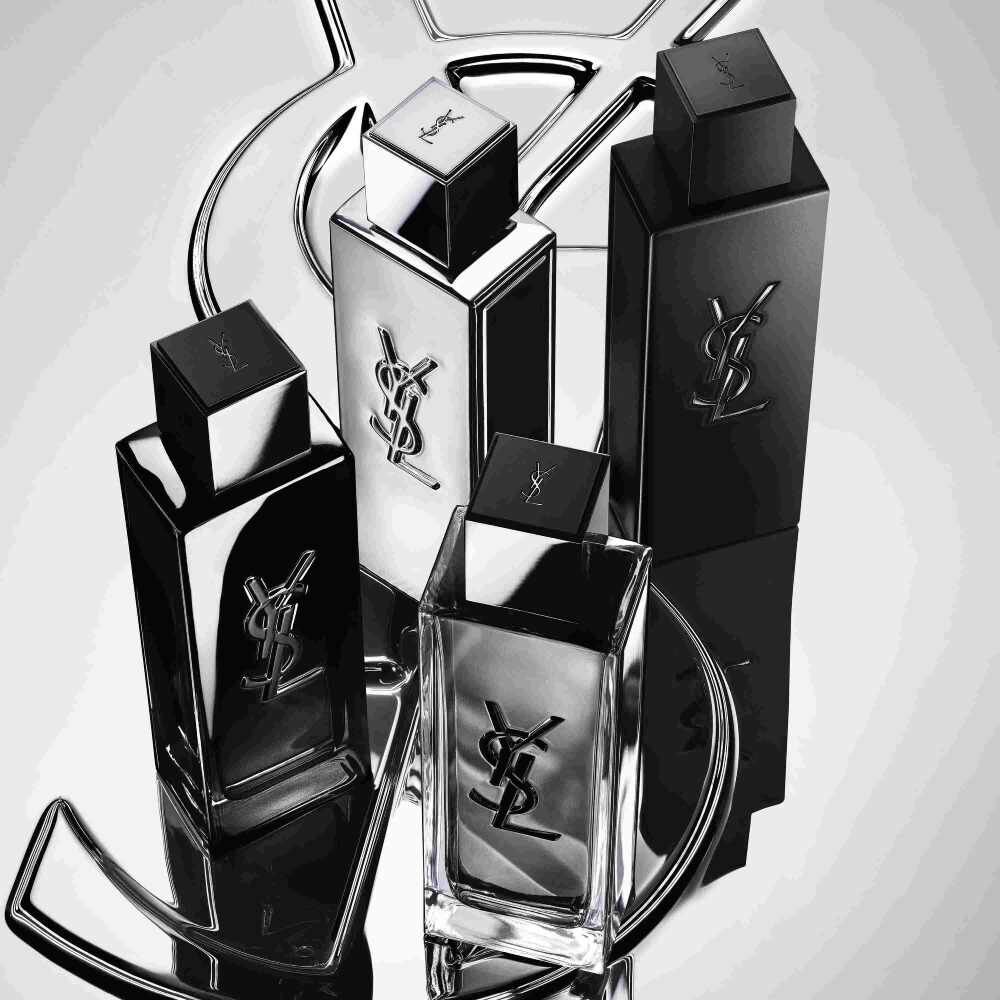  Cuatro frascos de perfume YSL en negro y plateado