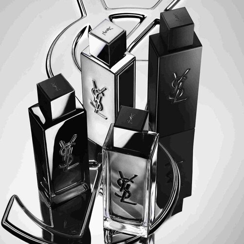Cuatro frascos de perfume YSL en negro y plateado