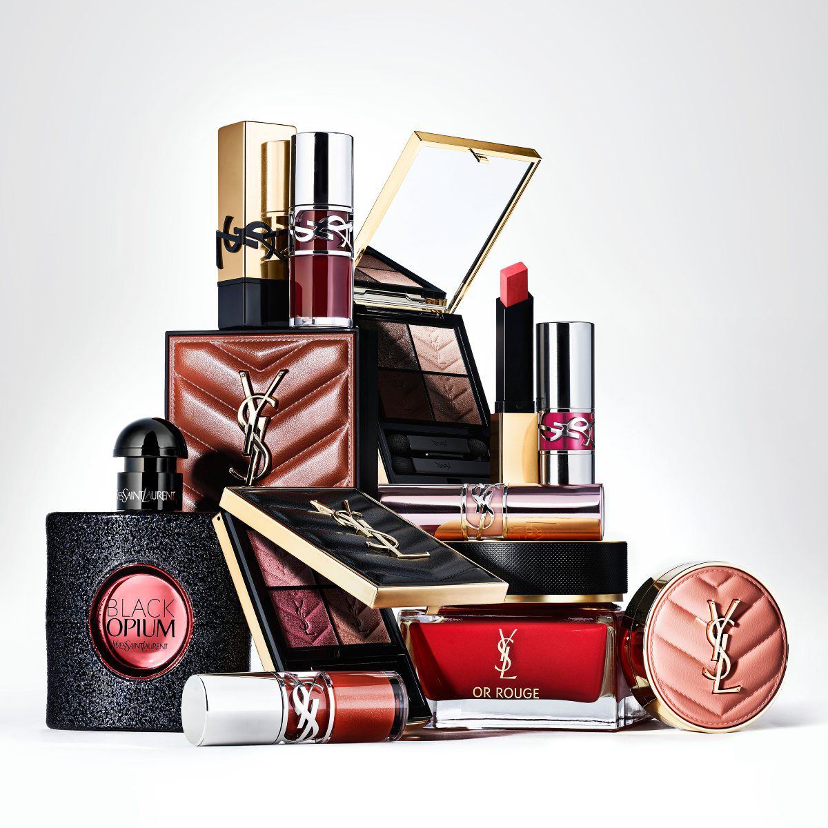 Una botella de perfume Yves Saint Laurent Libre y su recarga sobre una superficie de marmol con un fondo marmoleado.