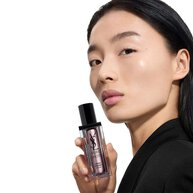 Wen, YSL Beauty model, holding Pure Shots Youth Reload Cream, highlighting skin-reshaping claims.