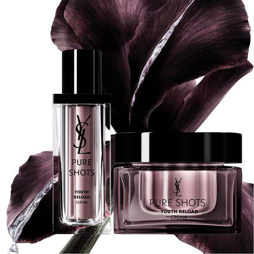Two purple skincare products with dark flower petals