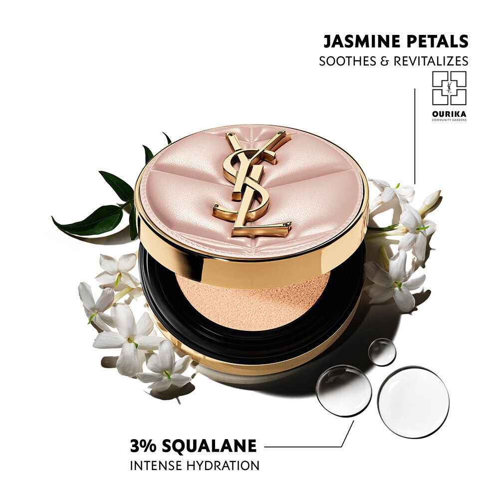 Pink quilted YSL SKIN AFFAIR CUSHION FOUNDATION with a gold logo, amidst white jasmine and water drops. Text highlights Jasmine Petals, Ourika Community Gardens, and 3% Squalane Intense Hydration.